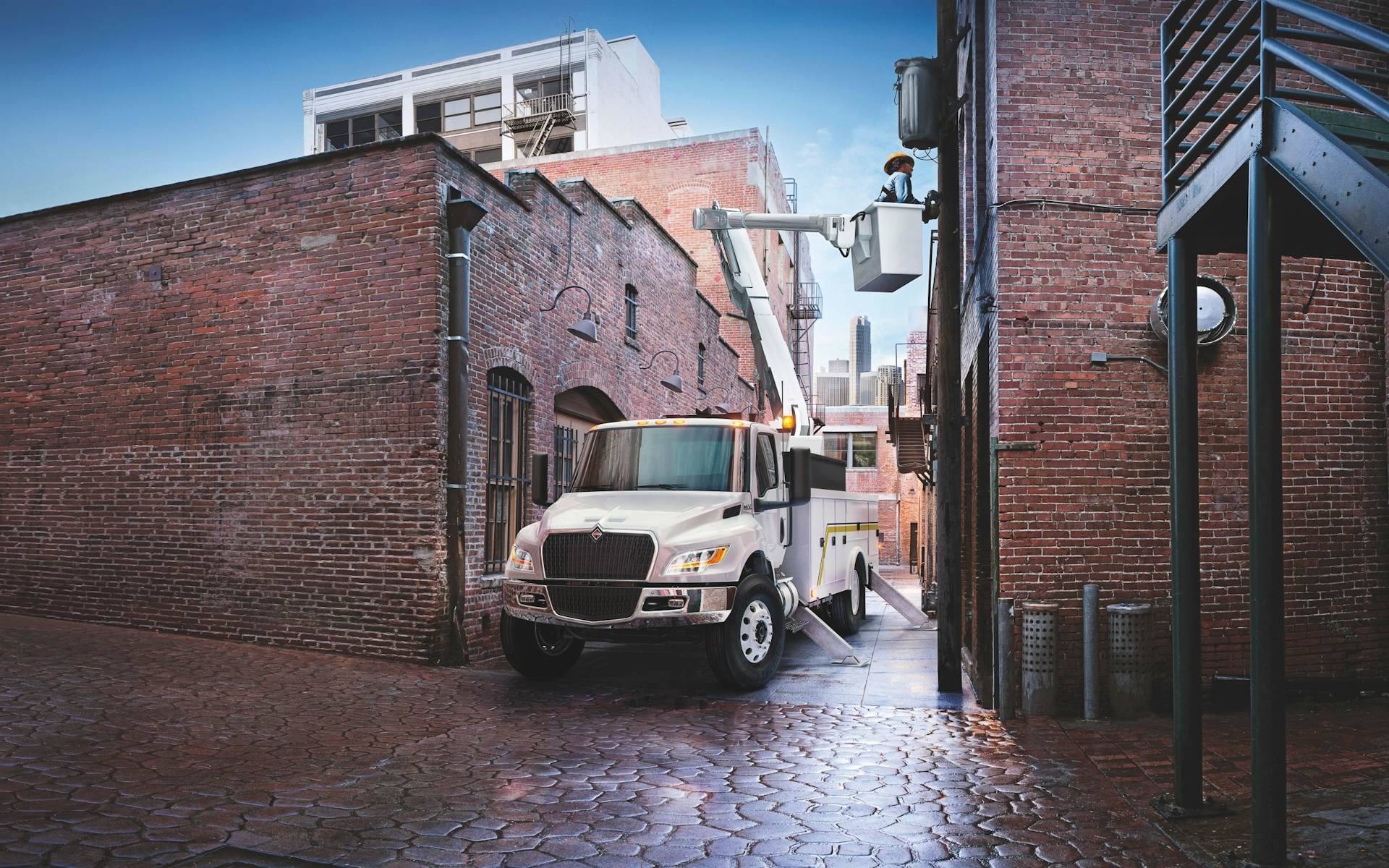 A white truck parked in a brick alley