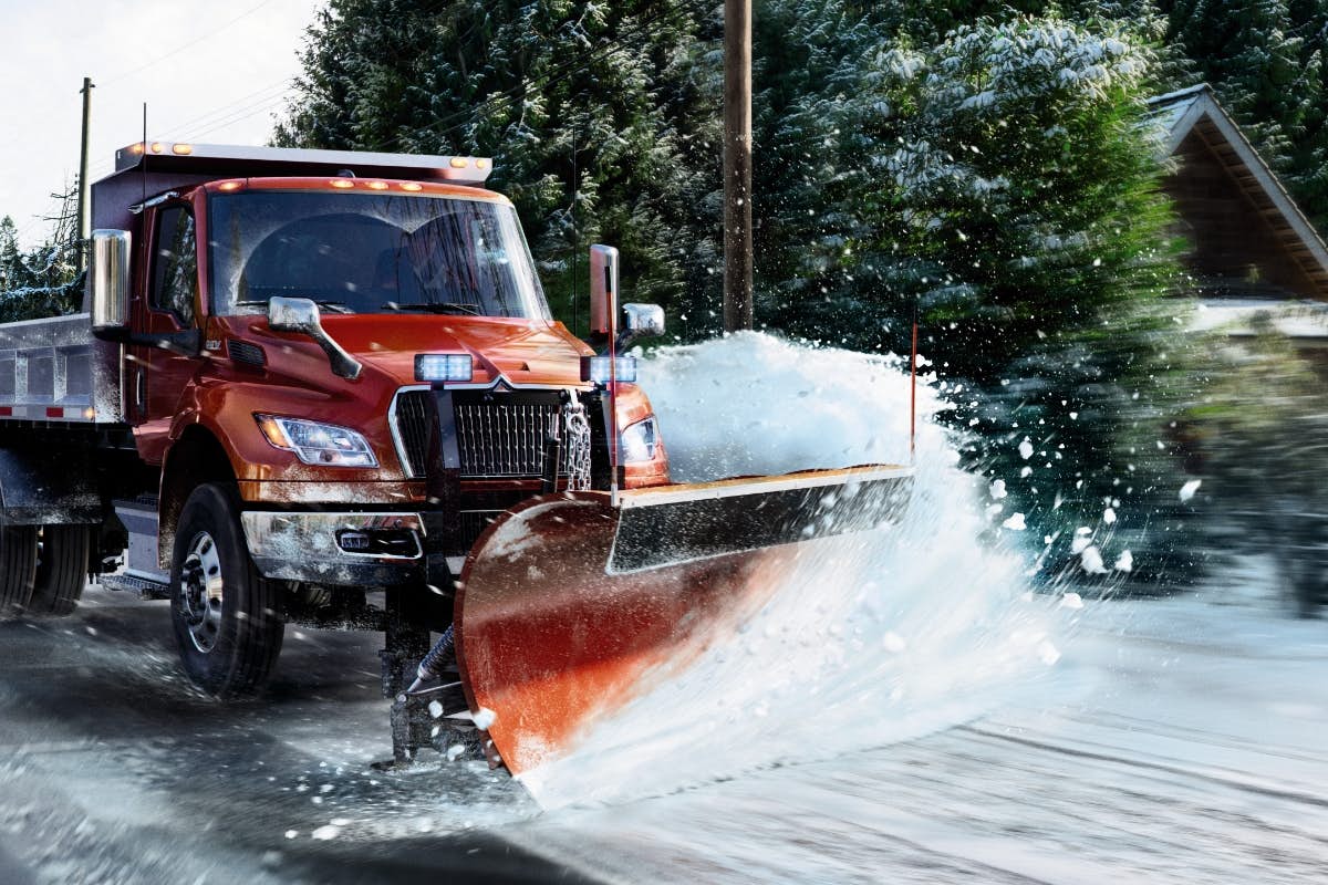 A snow plow truck on a road