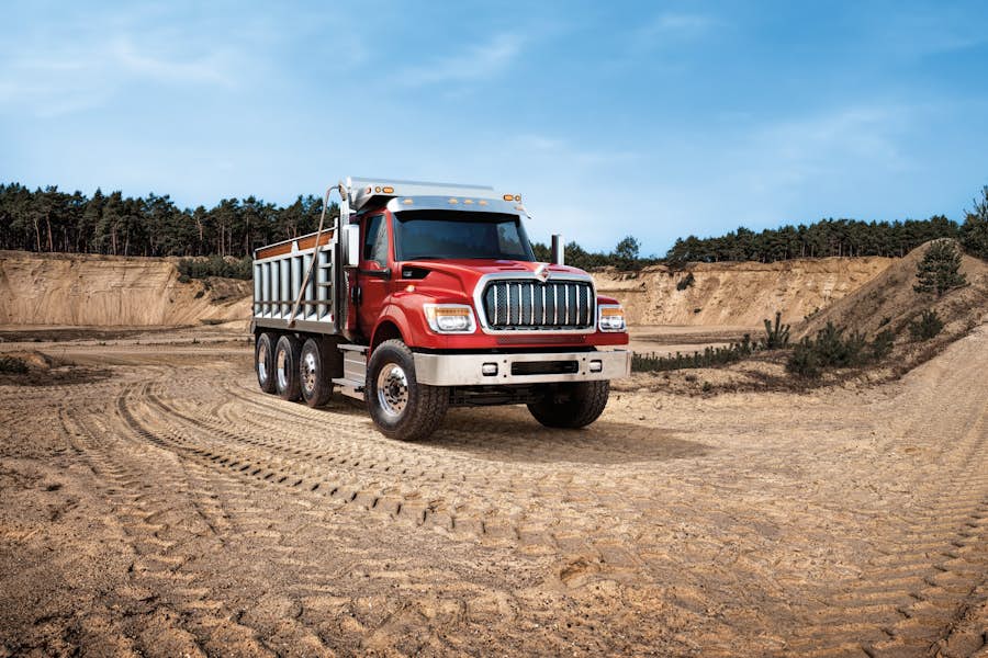 A red truck on a dirt road
